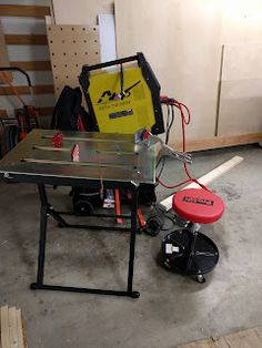 a workbench in a garage with tools on the table and other items around it