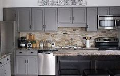 a kitchen with stainless steel appliances and gray cabinets