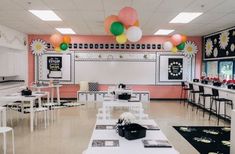 a classroom with tables, chairs and balloons