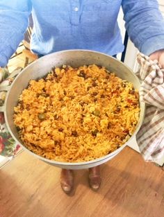 a person holding a pan full of food