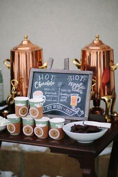 coffee cups and ice cream on a table with a chalkboard sign in the background