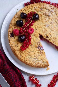 a piece of cake with cherries on it and a slice missing from the pie