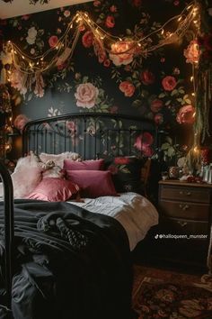 a bedroom with floral wallpaper and lights on the headboard, along with a black bed