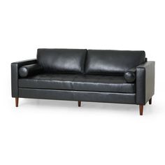 a black leather couch sitting on top of a white floor