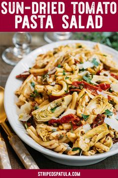 sun dried tomato pasta salad on a white plate