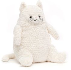 a white cat stuffed animal sitting on the ground