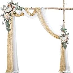 a white and gold wedding arch decorated with flowers