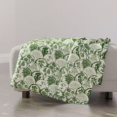 a couch with a green and white blanket on it