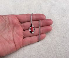 "Simple, chic and versatile! Here is a red stone necklace that is set in a perfectly detailed silver frame. The perfect everyday necklace! Made from allergy free plated silver. The pendant measures 1\" long by 1/2\" wide. It hangs from a shiny strong 18\" stainless steel necklace chain with a lobster clasp. I have matching earrings in my shop if you would like the whole set. Here is the link https://etsy.me/2R5NsWx I have this same style pendant necklace available in other color ways as well! He Southwestern Style Red Necklace For Gift, Red Southwestern Turquoise Necklace For Gift, Nickel-free Southwestern Style Necklace As Gift, Southwestern Style Nickel-free Necklace For Gift, Red Southwestern Sterling Silver Necklace, Southwestern Style Teardrop Pendant Jewelry Gift, Red Southwestern Style Jewelry Gift, Southwestern Style Red Jewelry For Gift, Southwestern Style Red Jewelry For Gifts