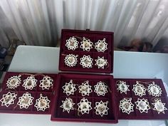 four red trays filled with white snowflakes on top of a table next to each other