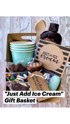 a box filled with lots of different items on top of a wooden table next to a bottle