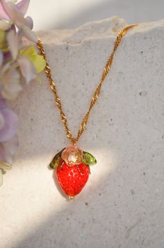 "Amalfi red strawberry  necklace, glass strawberry necklace, food necklace, fruit necklace, summer necklace, custom necklace, gift for her Inspired by nature, this lovely necklace is perfect for giving your outfit a taste of summer. This chain necklace is of made of 18k gold plated stainless steel  for an everlasting jewelry. The pendant is composed of pretty Czech crystal pink orange flower, green leaves, and at the bottom, a red strawberry, also made of Czech crystal. Floral and fruity, these earrings smell like summer, so don't hesitate to get them.  Each piece is made with a lot of love and care. ❤️ DETAILS: ♥ Dimension:  38cm (14.9\") to 45cm (17.71\") -pendent: 0.60cm (0.23\") ♥ Material: stainless steel, gold plated 18k ♥ Style: minimalist High quality materials. Packed with love an Sweet Jewelry With Fruit Design For Gift, Cute Fruit Design Jewelry For Gifts, Cute Fruit Design Jewelry As Gift, Sweet Strawberry Print Jewelry As Gift, Food Necklace, Strawberry Necklace, Fruit Necklace, Fruit Jewelry, Flower Green