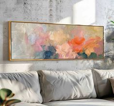 a painting hanging on the wall above a couch