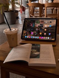 an open book sitting on top of a wooden table