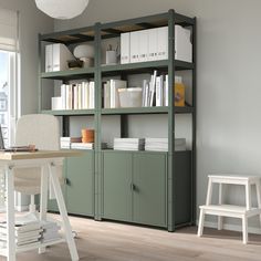 a room with a desk, chair and bookshelf