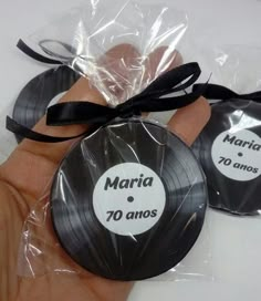 two black and white records are wrapped in clear cellophane to be used as wedding favors