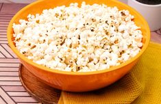 a bowl filled with popcorn sitting on top of a table