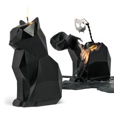 a black cat statue sitting on top of a table