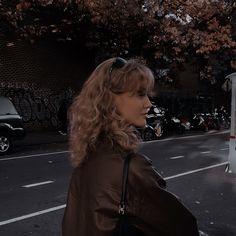 a woman standing in the middle of a street