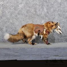 a dog dressed up like an animal with horns and boots on it's back legs