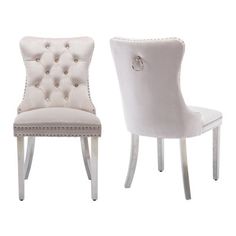 two white chairs side by side with buttons on the upholstered backrests