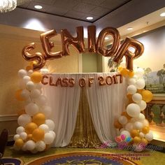 an entrance decorated with gold and white balloons