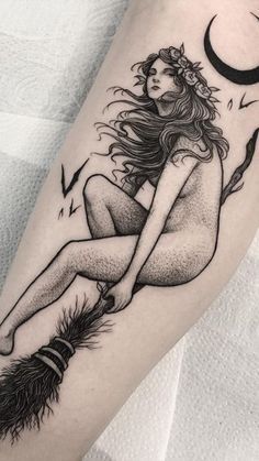 a woman sitting on top of a feather next to a moon and crescent tattoo design