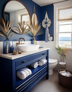 a bathroom with blue walls and gold accents