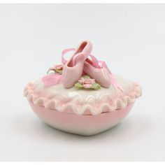 a pink ballerina's shoe sitting on top of a bowl