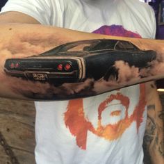 a man with a car tattoo on his arm