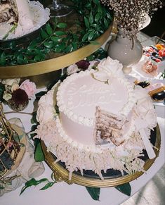 there is a cake on the table with flowers and other items around it that are also decorated