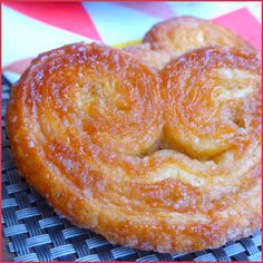 two doughnuts sitting on top of a blue and white checkered table cloth