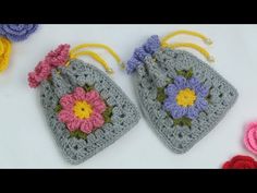 two crocheted bags with flowers on them