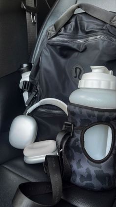 the back seat of a car with an open bottle and other items in its pouch