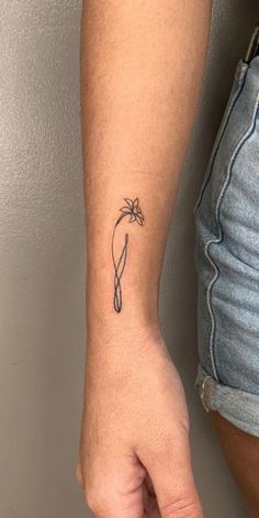 a person with a small tattoo on their arm