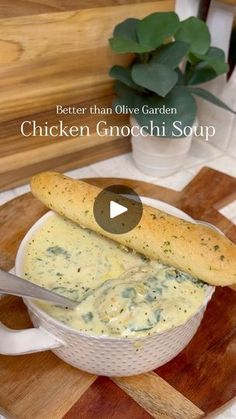 chicken gnocchi soup in a white bowl on a cutting board with a knife