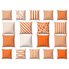 many orange and white pillows are arranged on a white surface, each with different patterns