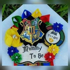 the hogwarts crest is decorated with flowers and ribbons