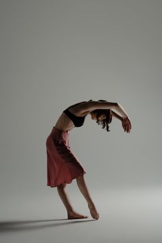 a woman is doing a handstand in the air