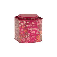 a pink box with flowers on it and the lid is open to show its contents