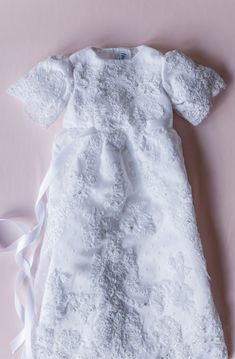 Blessed For Generations to Come Transform your own wedding gown fabric and its exquisite embellishments into a treasured family keepsake. This exquisite, one-of-kind, Christening or Baptism Gown is custom designed and hand constructed with attention to detail. Features: Embellished bodice and skirt Fully lined gown Velcro back closure Satin ribbon belt Artisan crafted for exquisite handiwork detail Matching bonnet option available Give the gift that wraps baby in love in the most special way pos Embroidered Tulle Dress For Ceremonies, Elegant Embroidered Lace Baptism Dress, Embroidered Fitted Gown For Pageant, Embellished Gown With Fitted Bodice For Ceremonies, Organza Baptism Dress With Lace Bodice For First Communion, Elegant Organza Pageant Dress For Baptism, Elegant Fitted Baptism Dress With Embroidery, Elegant Tulle Baptism Dress For Ceremony, Elegant Fitted Embroidered Baptism Dress