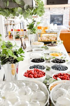 a long table filled with lots of plates and bowls full of different types of food