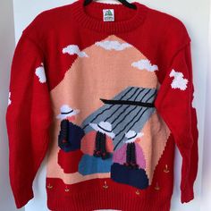 a red sweater with an image of a bird on it