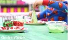 the child is playing with candy at the table