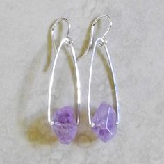 "Hammered Sterling Silver Triangular Earrings with Faceted Amethyst - Amethyst Earrings - Purple Earrings - Purple Gem These earrings feature delicate, lightly hammered, sterling silver wire that is formed into rounded triangular shapes. They are accented at the bottom with incredible, faceted, purple amethyst nuggets and dangle from sterling silver French earwires. These purple earrings are simply beautiful - light and airy with a splash of color! Details Metal Type: Sterling silver wire Bead S Modern Amethyst Gemstone Earrings, Modern Amethyst Earrings As Gift, Modern Purple Gemstone Earrings, Turquoise Hoop Earrings, Purple Gems, Unusual Earrings, Turquoise Bracelet Cuff, Purple Earrings, Hammered Sterling Silver