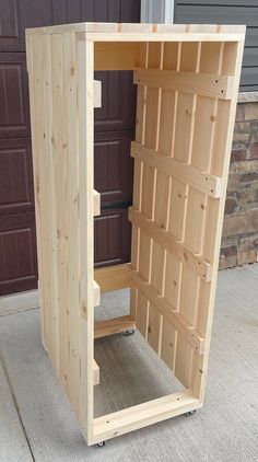 a wooden cabinet sitting in front of a garage door