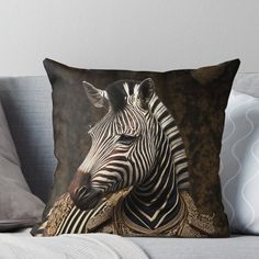 a black and white zebra throw pillow sitting on top of a couch with its head turned to the side