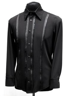 A classic cut, formal shirt for any occasion. A comfortable black rayon shirt with an elegant, tapered fit. Pleated black ribbon trim down the front adds a subtle, understated flair. Fastens in front and at cuffs with rich black pearl snaps. Smoooth! Comes in sizes Small-3X. Measurements: Small: Chest 38-42" Waist 30-32" Medium: Chest 42-44" Waist 32-38" Large: Chest 44-46" Waist 38-42" XL: Chest 48-50" Waist 42-44" XXL: Chest 50-52"" Waist 44-49" 3X: Chest 54' Waist 49" Classic Fitted Black Shirt, Classic Black Formal Tops, Black Fitted Shirt For Semi-formal Occasions, Black Fitted Formal Shirt, Classic Tailored Black Tops, Tailored Classic Black Tops, Classic Black Formal Shirt, Fitted Black Top For Formal Occasions, Black Long Sleeve Dress Shirt For Party