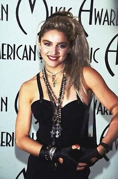 a woman in a black dress posing for the camera