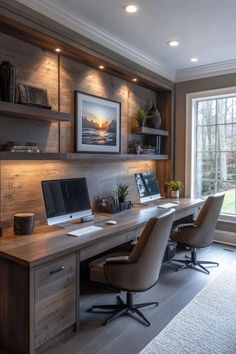 a home office with built in shelving, desk and computer on the far wall